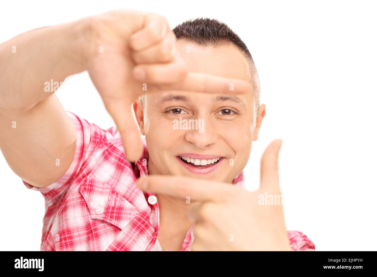 Close-up on a young Caucasian guy framing a photo with his fingers isolated on white background Stock Photo