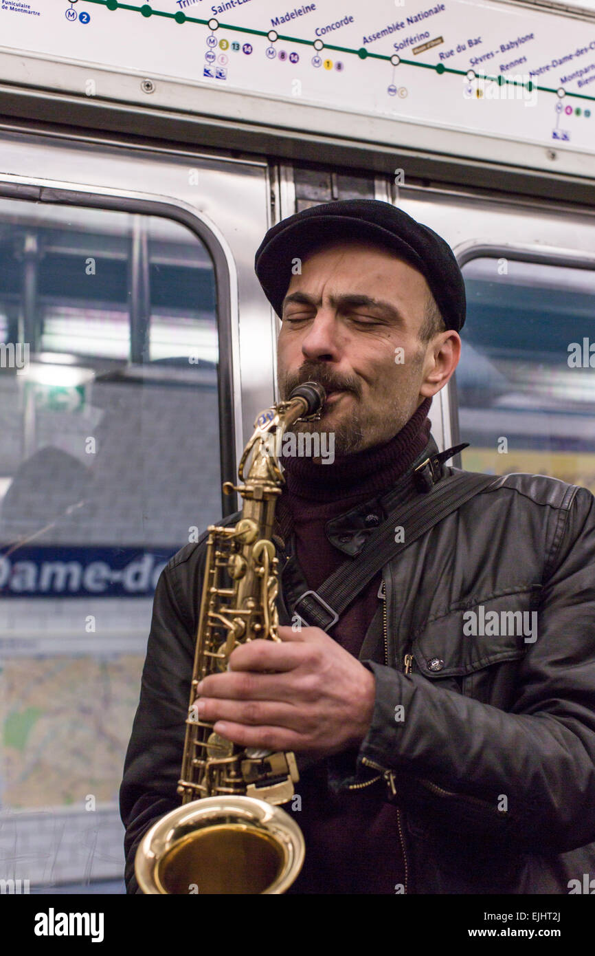 Busker playing saxophone on Metro, Paris, France Stock Photo