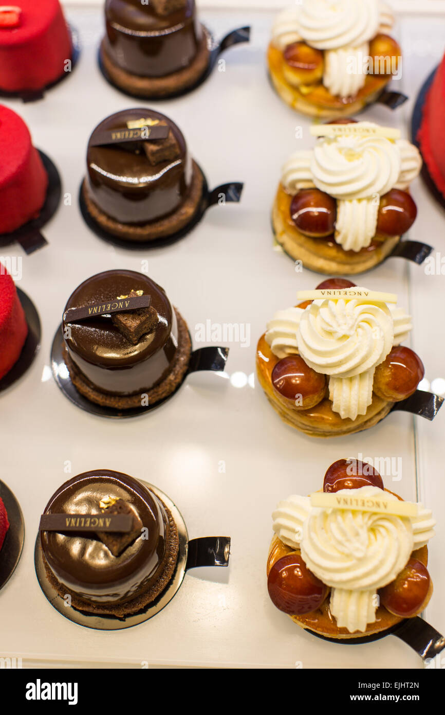 Angelina cakes in display case with signs, Paris, France Stock Photo