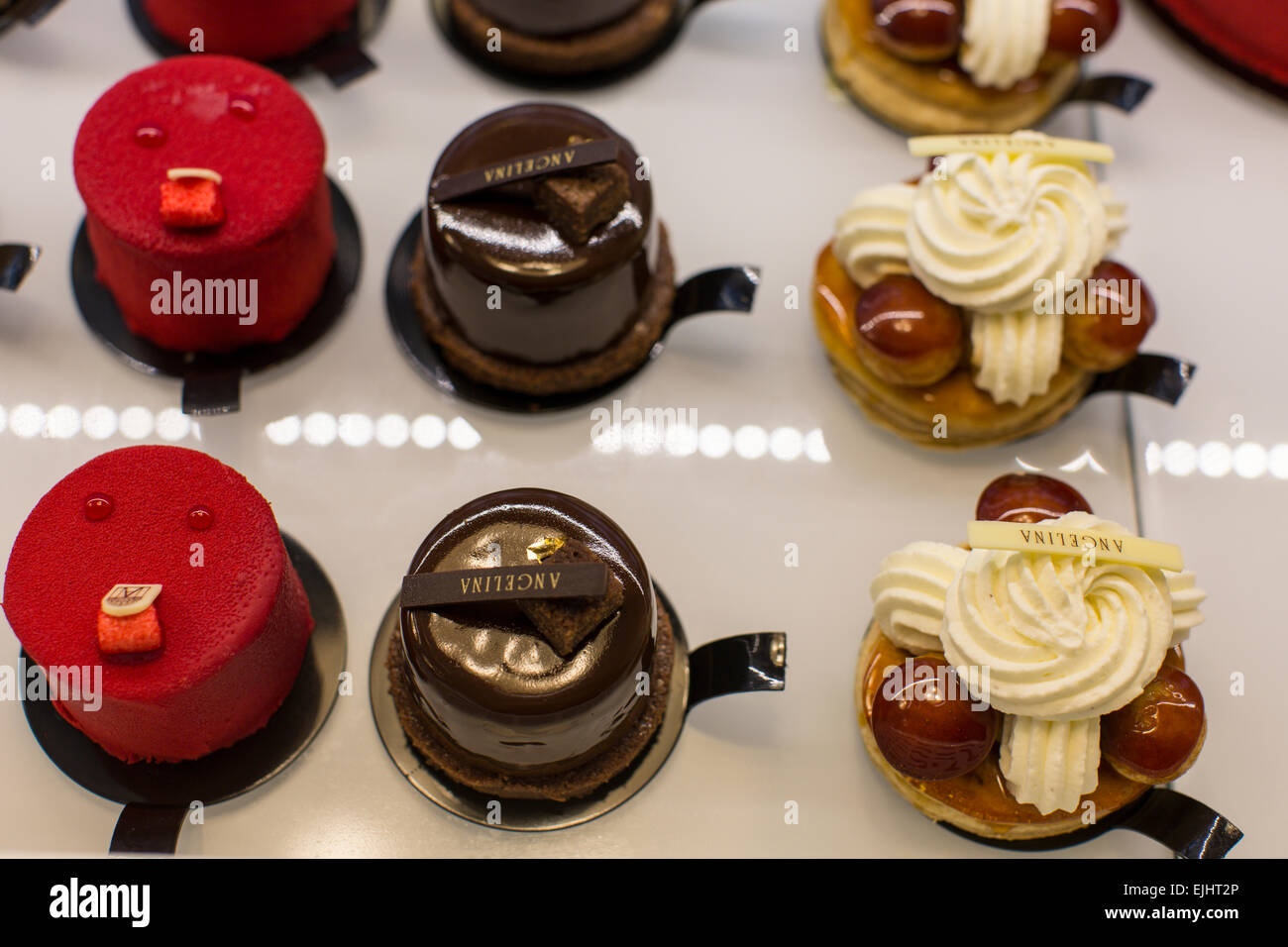 Angelina cakes in display case with signs, Paris, France Stock Photo