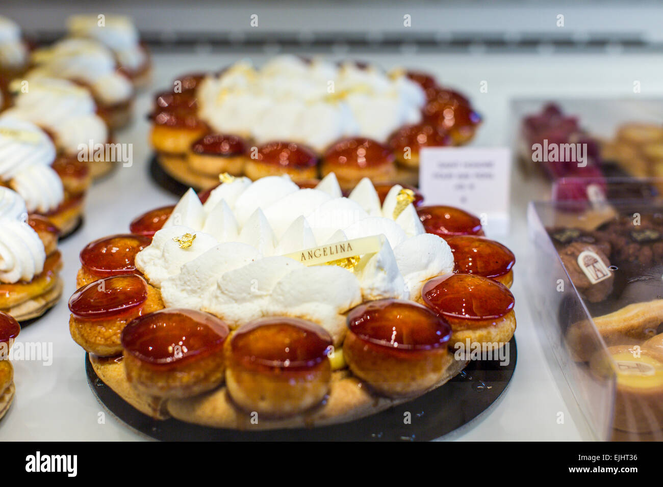 Angelina cakes in display case with signs, Paris, France Stock Photo