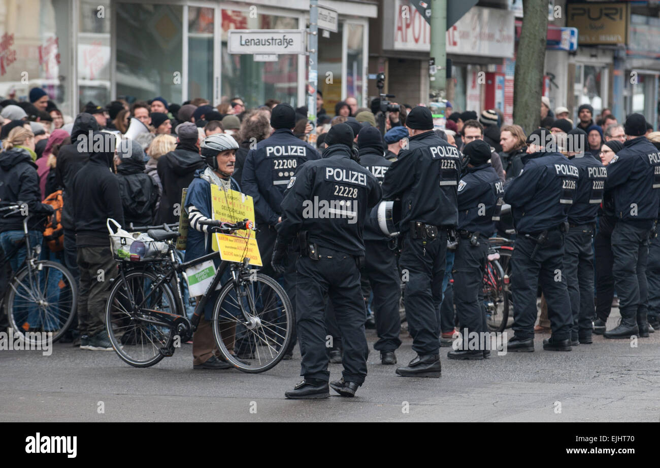 Berlin, Germany. 27th Mar, 2015. Police officers are standing next to a group of protesters at the Kottbusser Damm in Berlin, Germany, 27 March 2015. Around 250 people demonstrated against the forced eviction of the cultural center Allmende in Berlin's district Kreuzberg. PHOTO: PAUL ZINKEN/dpa/Alamy Live News Stock Photo