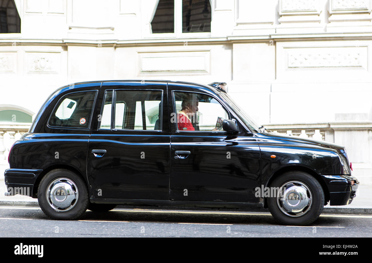 Black London cab with cabbie, London, England Stock Photo