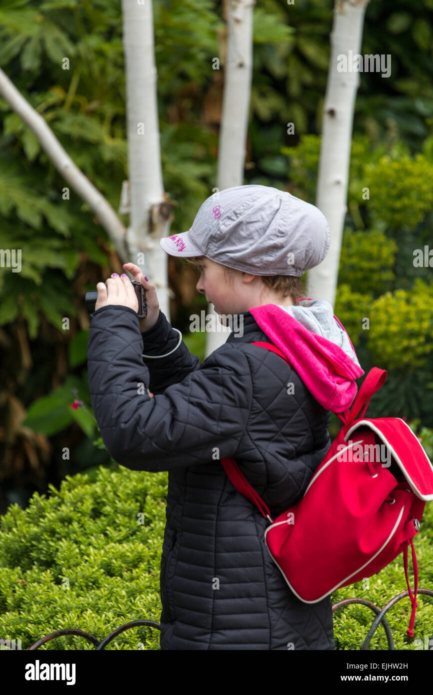 Young girl taking photos in St. James's Park, London, England Stock Photo