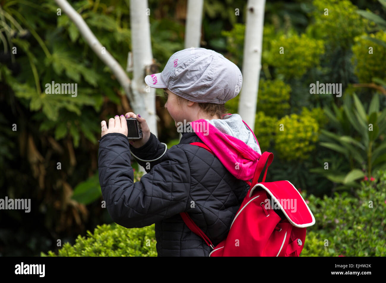 Young girl taking photos in St. James's Park, London, England Stock Photo