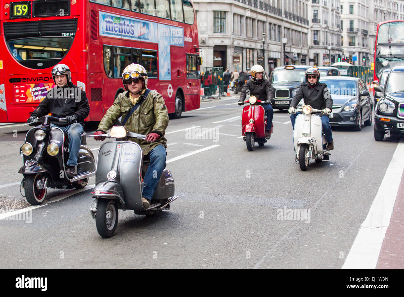Men on motor scooters on Regent Street, London, England Stock Photo