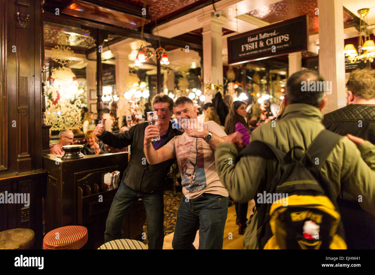 Two men posing and laughing inside the Salisbury pub, London, England Stock Photo