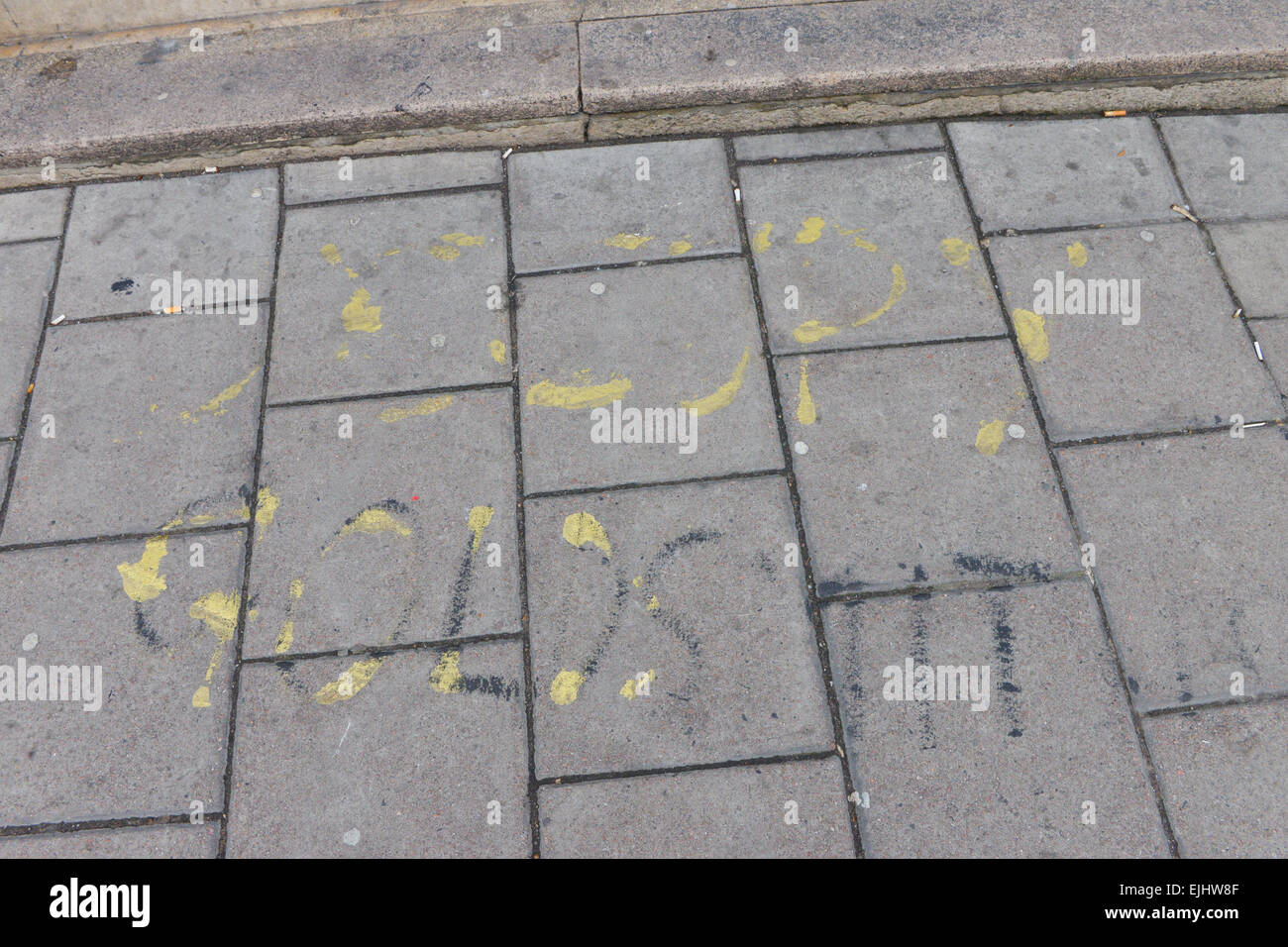 New Cross Gate, London, UK. 27th March 2015. Faded graffiti on the pavement. Students are occupying Deptford Town Hall, the management building for Goldsmiths College. Part of the growing Occupy movement against cuts in education that began with the Occupy UAL at St Martins. Credit:  Matthew Chattle/Alamy Live News Stock Photo