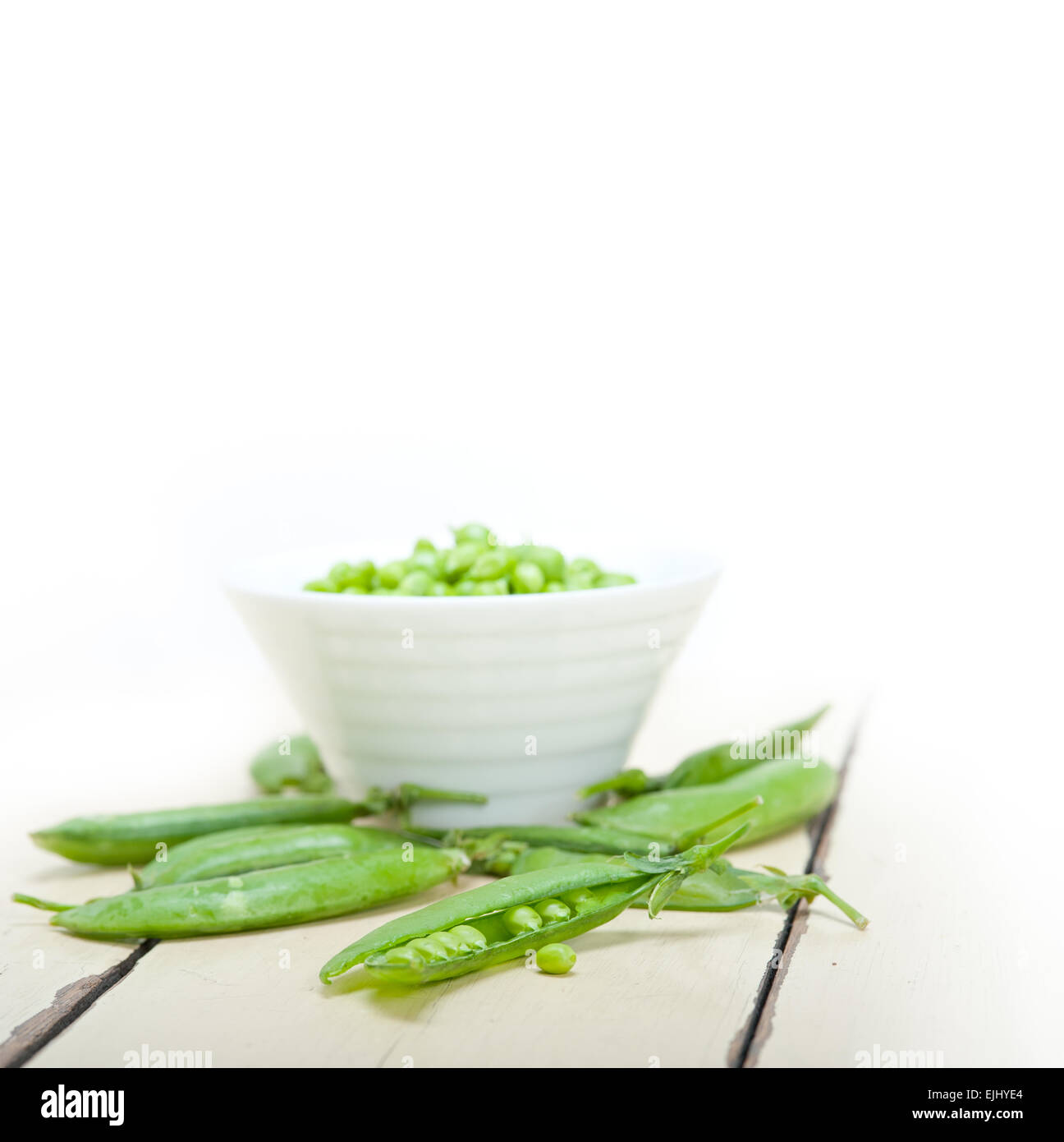 hearthy fresh green peas  over a rustic wood table Stock Photo