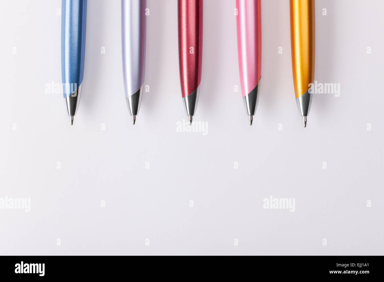 Premium Photo  Ballpoint pens on a colorful background.