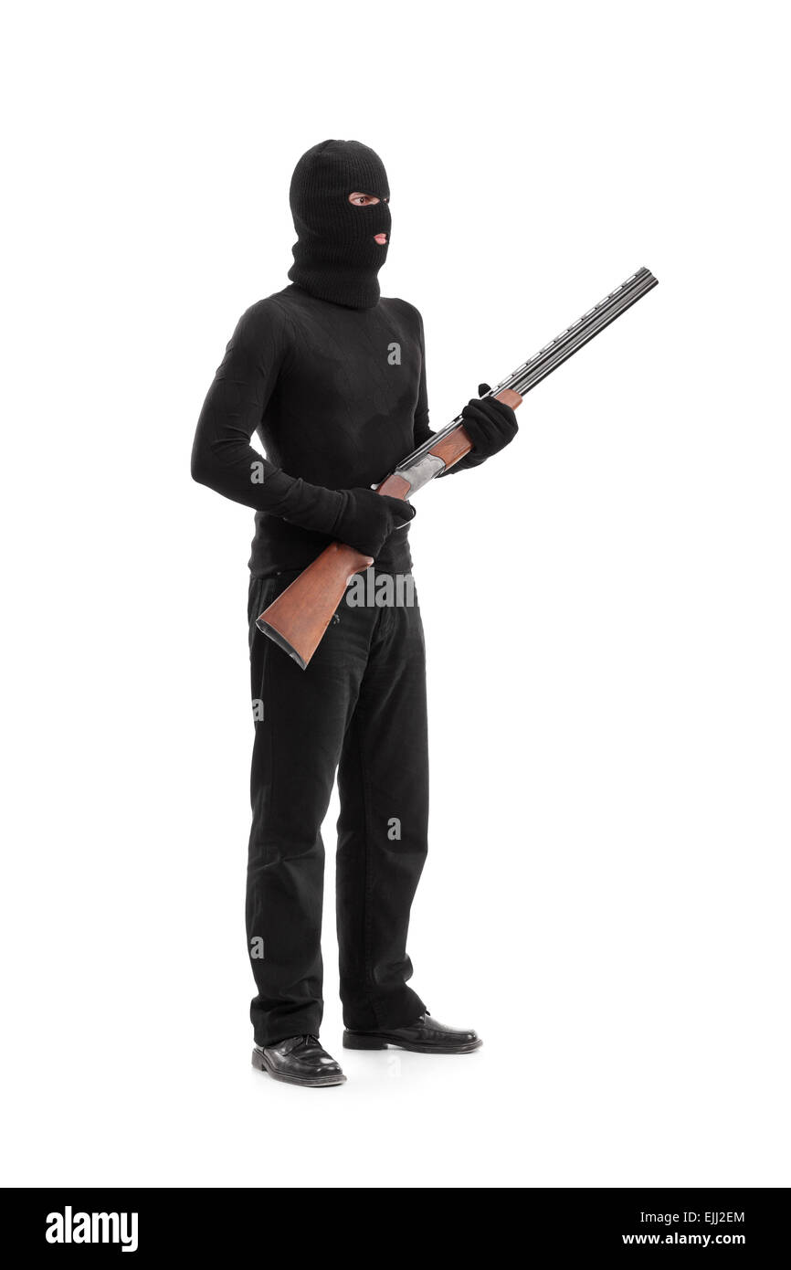 Full length portrait of a dangerous criminal holding a shotgun rifle isolated on white background, studio shot Stock Photo