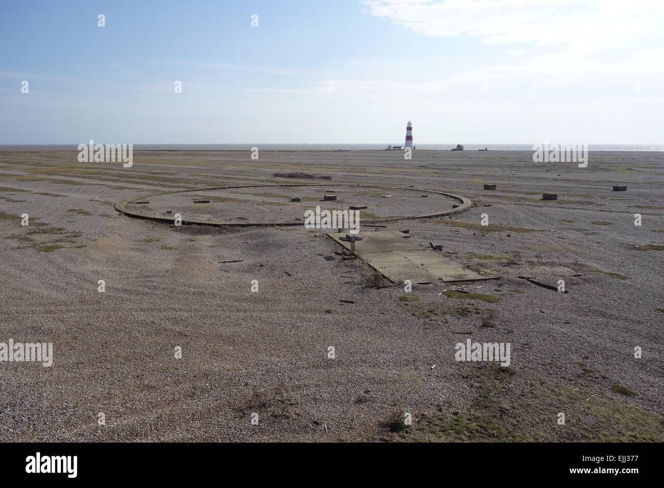 Orford Ness, Suffolk, remains of footings for defence structures set in unaltered shingle ecology lighthouse in far distance Stock Photo