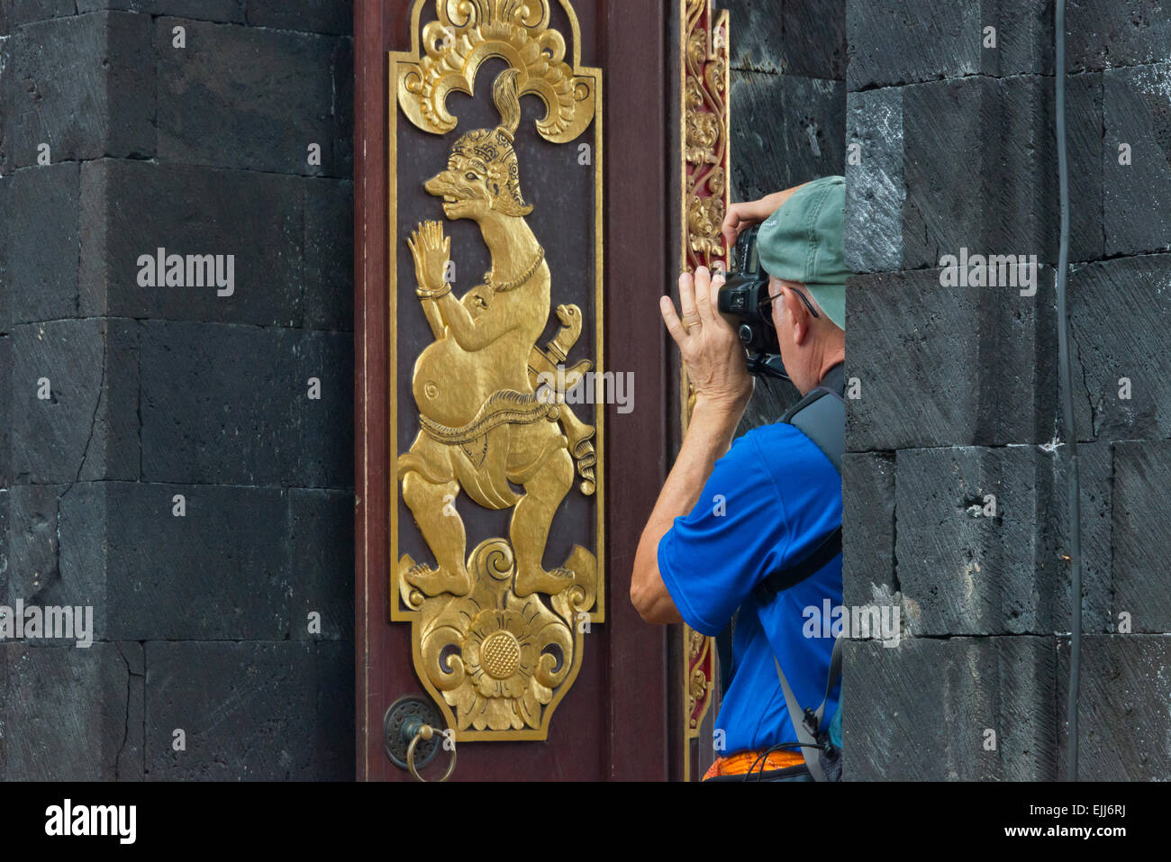 Tourist photographing decorated door in Mother Temple of Besakih, the most important, largest and holiest temple of Hindu religi Stock Photo