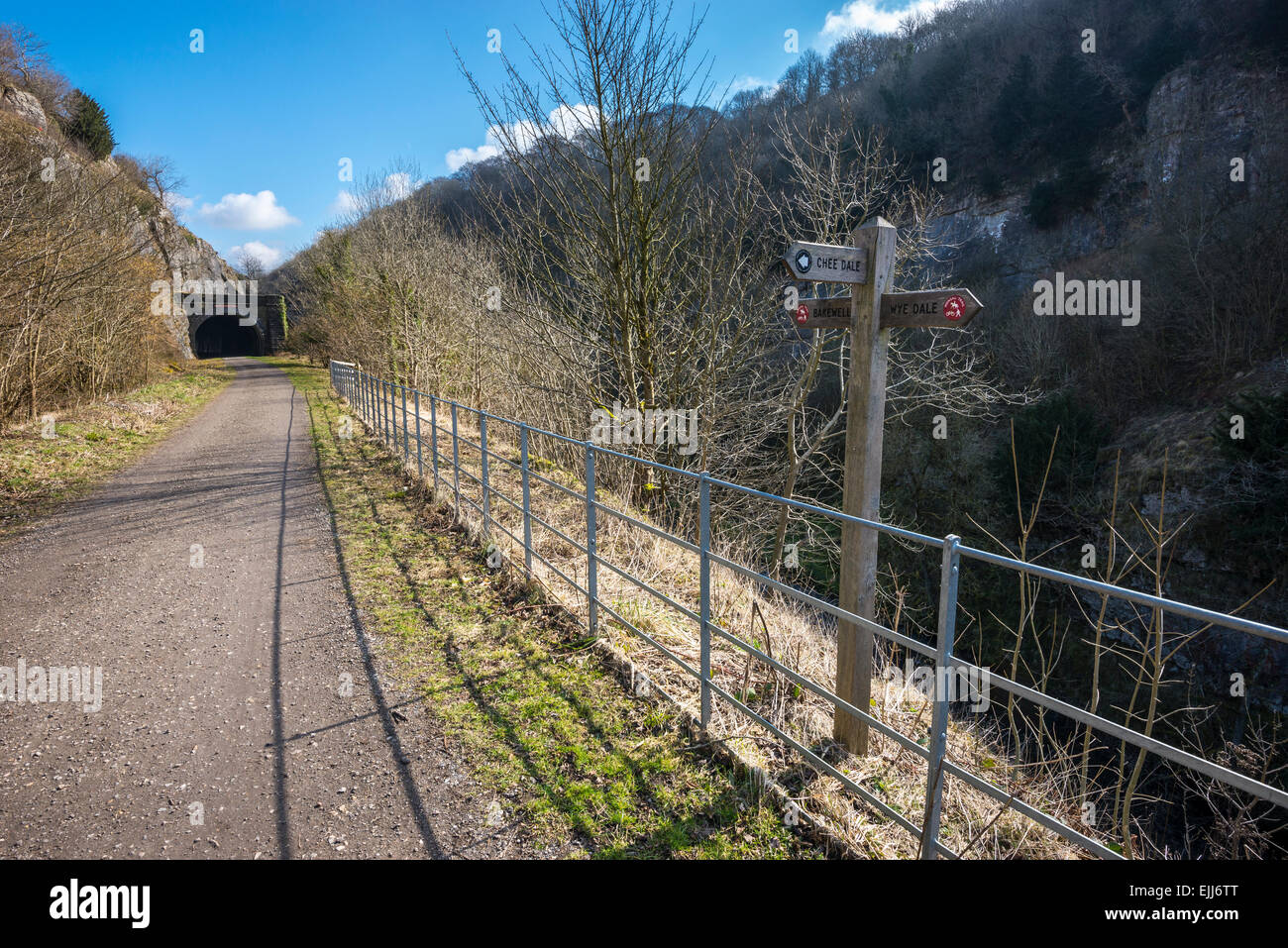 Sign post on the Monsal trail in the Peak District, Derbyshire. Spring sunshine on the path leading to one of the tunnels. Stock Photo