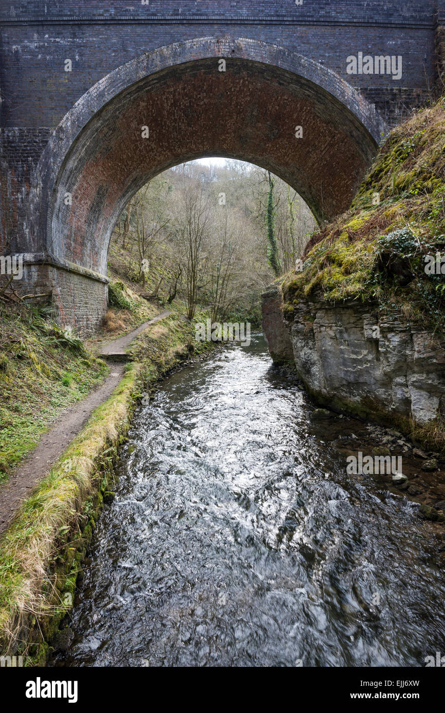 Old railway bridge on the Monsal trail over the river Wye in Chee Dale, Derbyshire. Path beside the river. Stock Photo