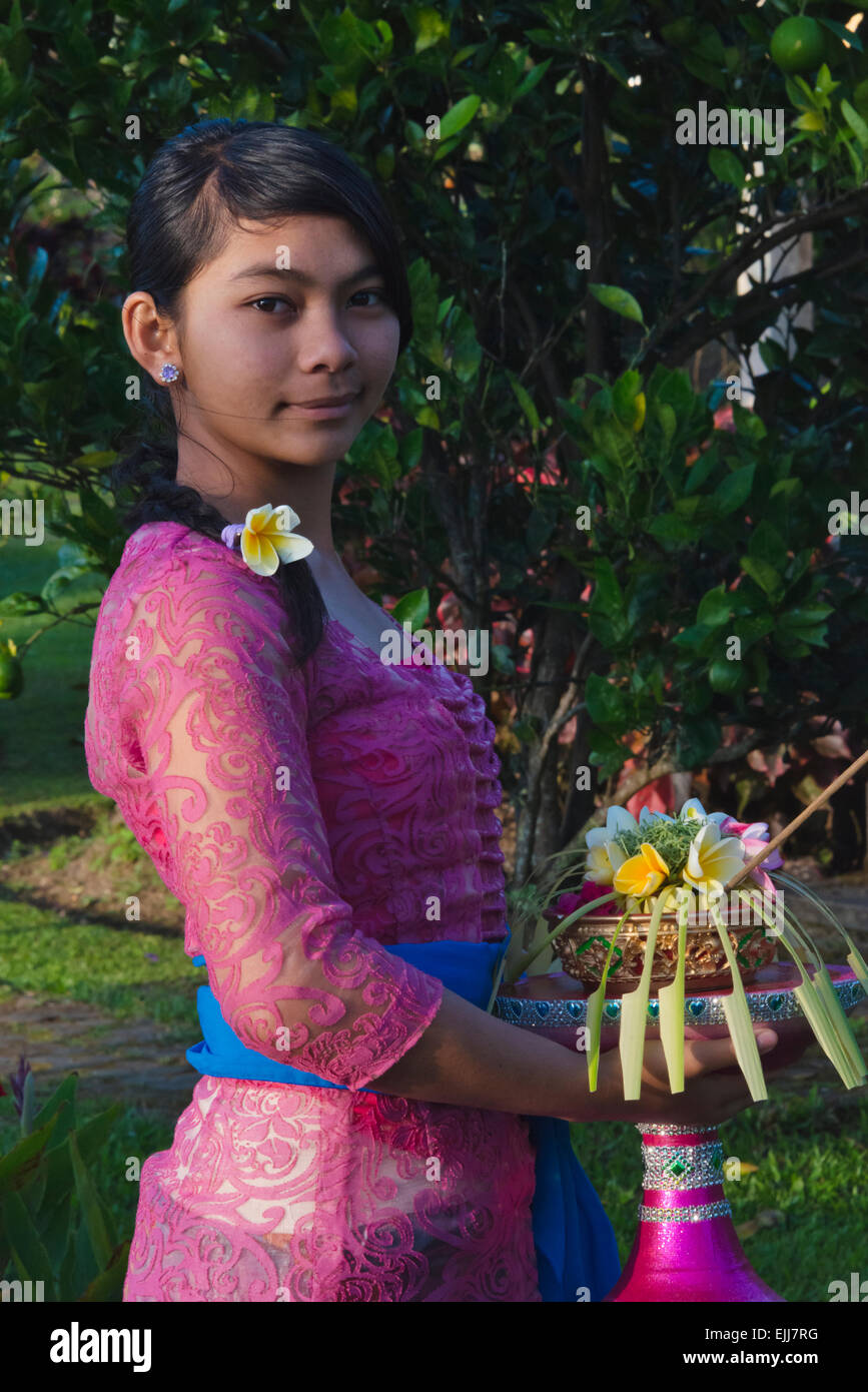 Girl carrying flower basket, Bali island, Indonesia Stock Photo