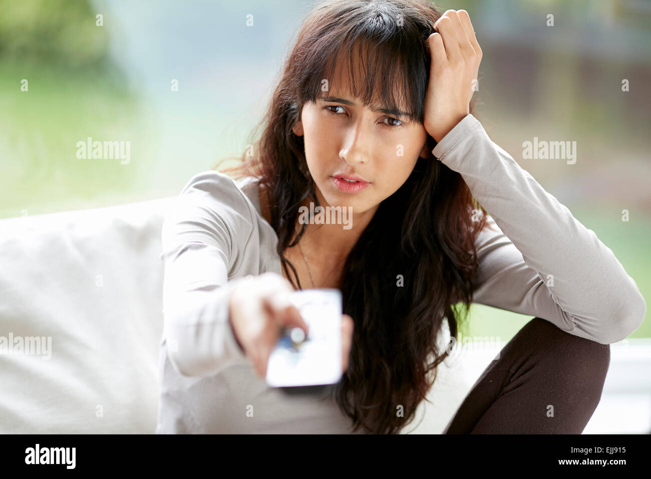 Bore teenager with tv remote Stock Photo