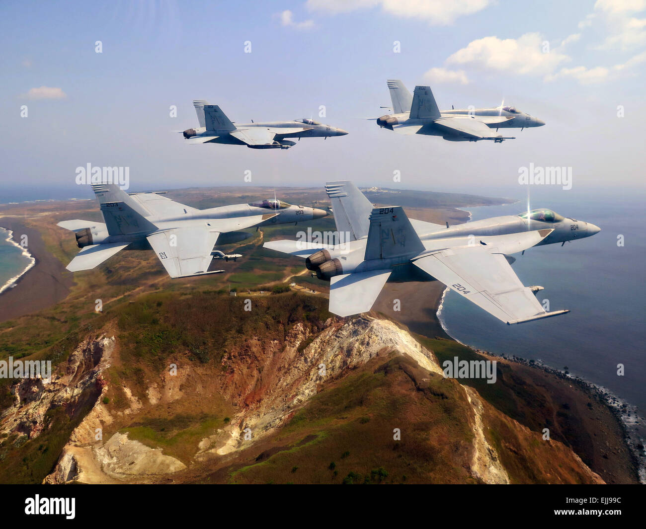 US Navy F/A-18E Super Hornet fighter aircraft fly in formation over Mt. Suribachi in honor of the 70th anniversary of the Battle of Iwo Jima March 25, 2015 in Iwo Jima Island, Japan. Stock Photo