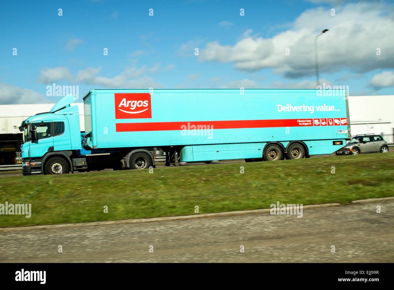 Panning with rear sync flash an ARGOS articulated lorry traveling along the Kingsway Dual Carriageway in Dundee, UK Stock Photo