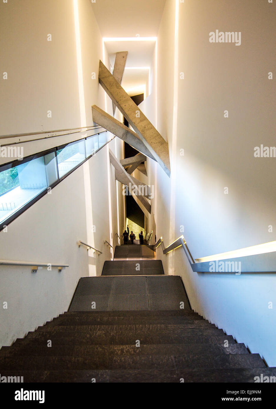 The long and steep central stairway inside the Jewish Museum in Berlin, Germany. Themes of random chaos are implied in the toppl Stock Photo