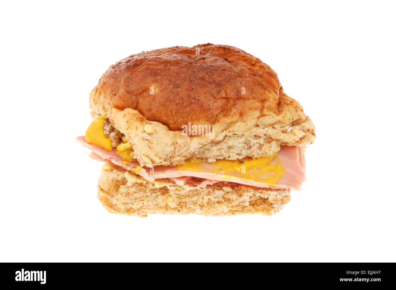Ham with mustard in a wholemeal bread roll isolated against white Stock Photo