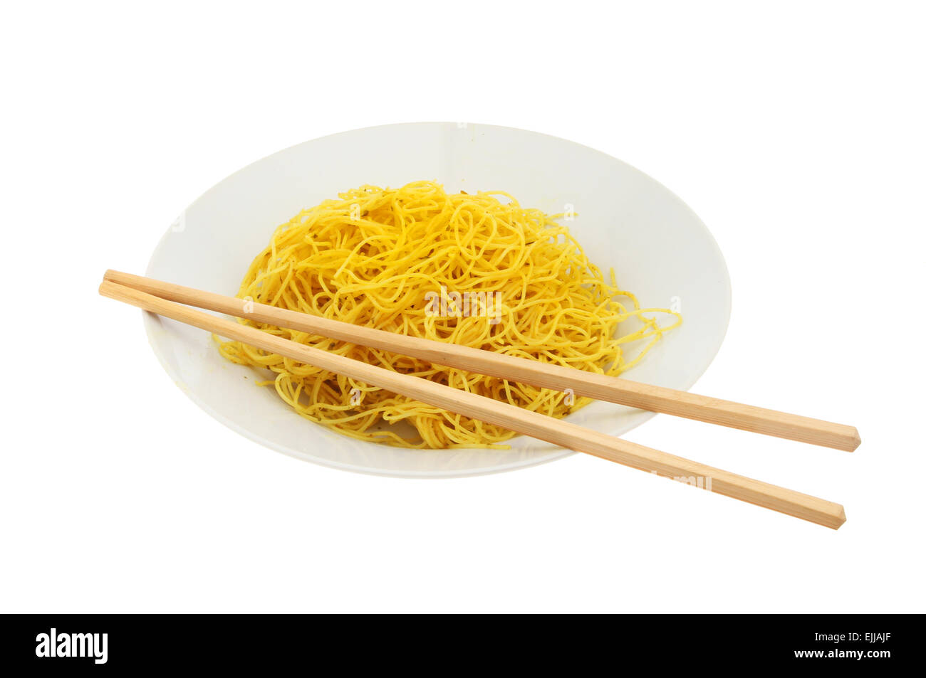 Singapore noodles in a bowl with chopsticks isolated against white Stock Photo