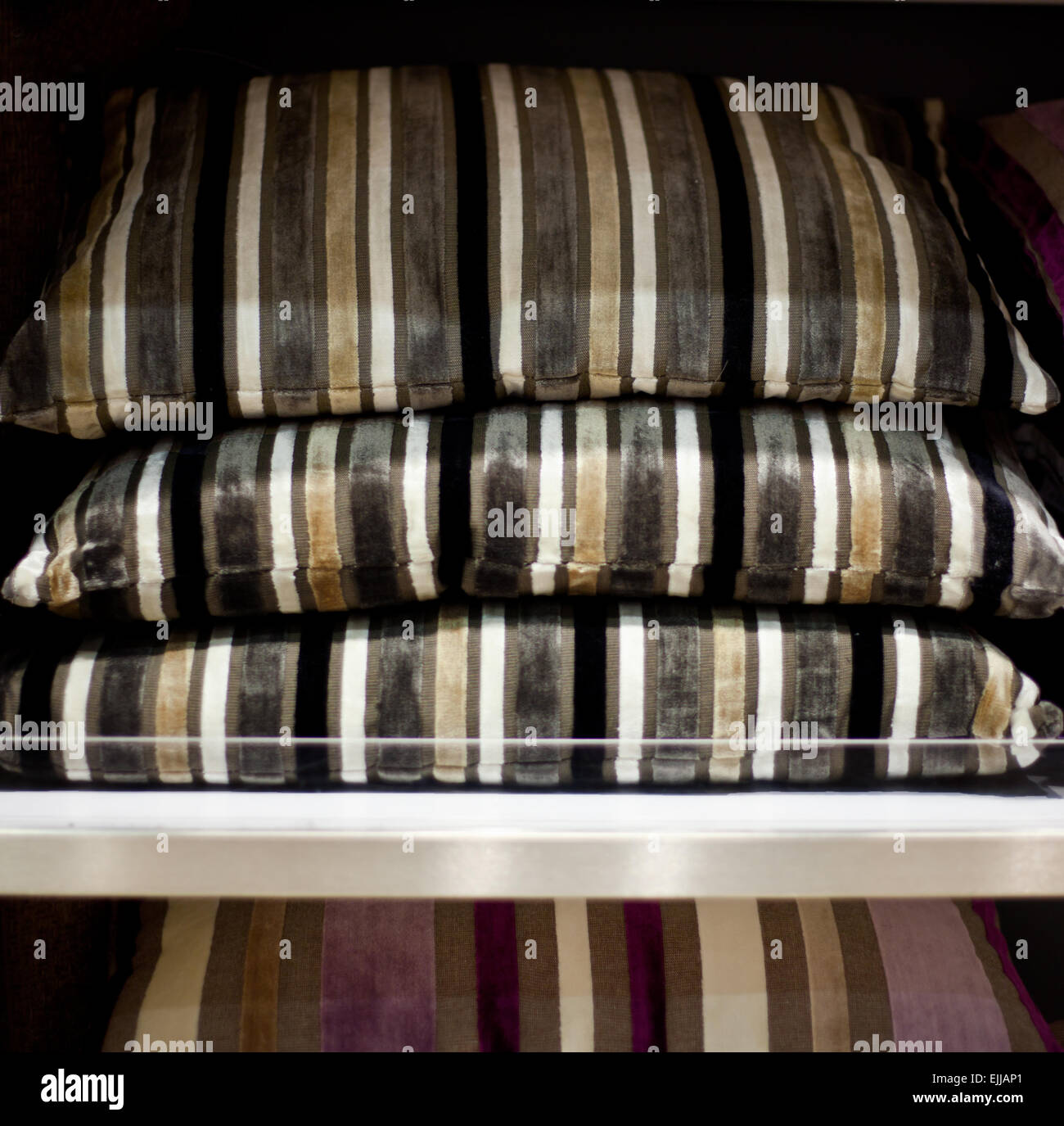Striped cushions on a shelf. Selective focus Stock Photo