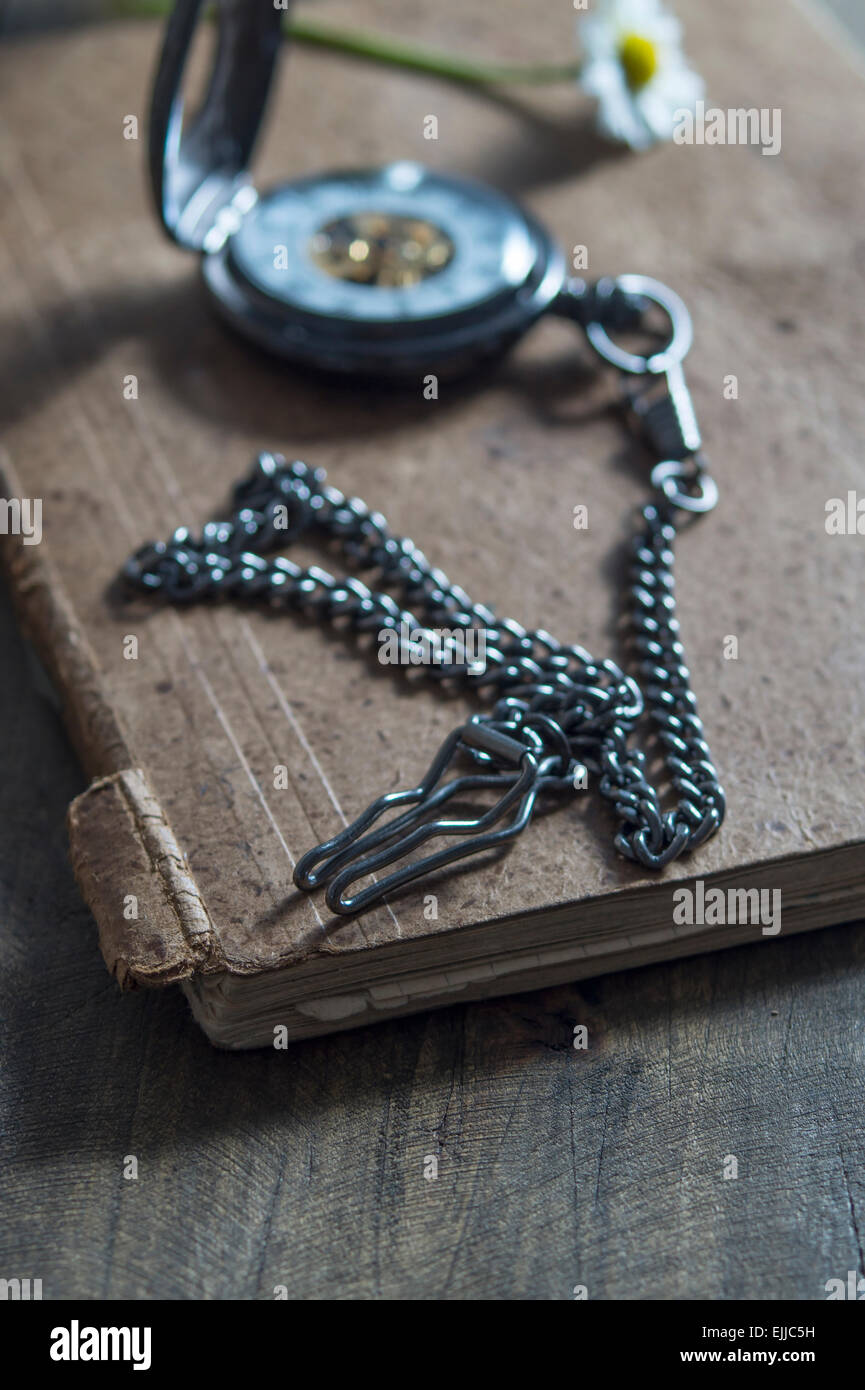 old pocket watch on old book,shallow depth of field Stock Photo