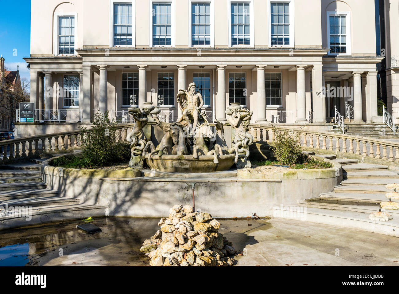 The Neptune Fountain in Cheltenham is a local landmark modeled on the Trevi Fountain in Rome showing sea god Neptune and horses Stock Photo