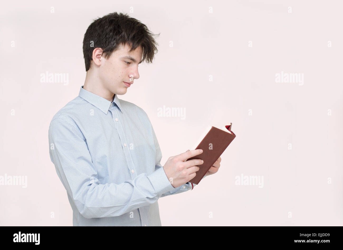Teenager reading a book isolated on white Stock Photo - Alamy