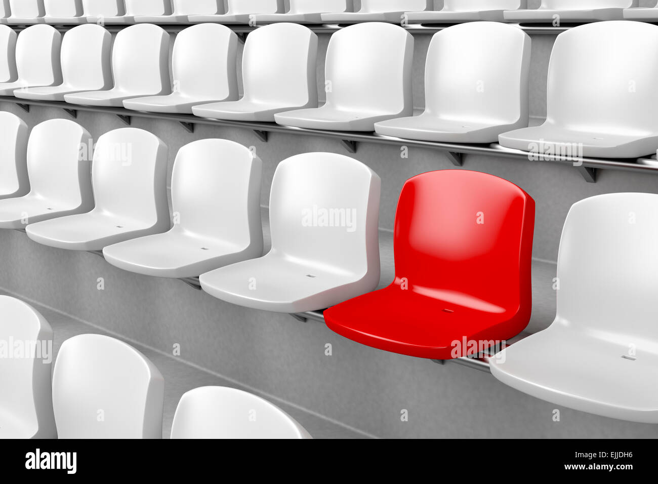 Unique red seat among white ones Stock Photo