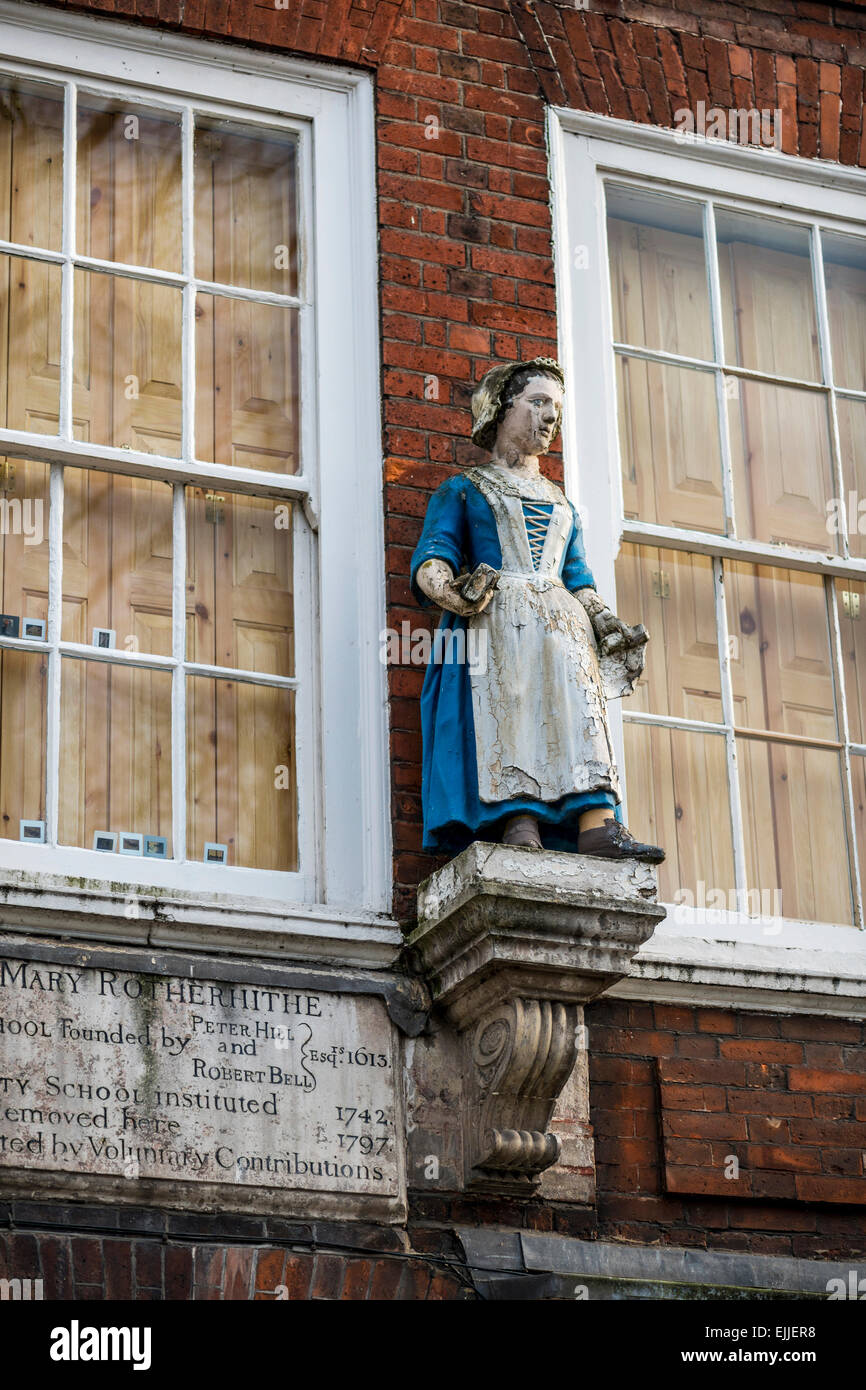 A figure of a female above the door of St Mary's Charity School, Rotherhithe London which is now residential accommodation Stock Photo