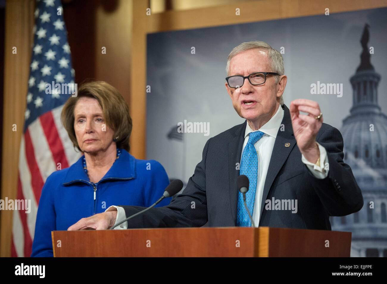 US Democratic Senate Leader Harry Reid wears medical glasses over his injured eye during a press conference as House Minority leader Nancy Pelosi looks on February 26, 2015 in Washington, DC. The 75-year-old Reid suffered an accident while exercising on New Year's Day resulting in four broken ribs and may leave him permanently blind in one eye. Stock Photo