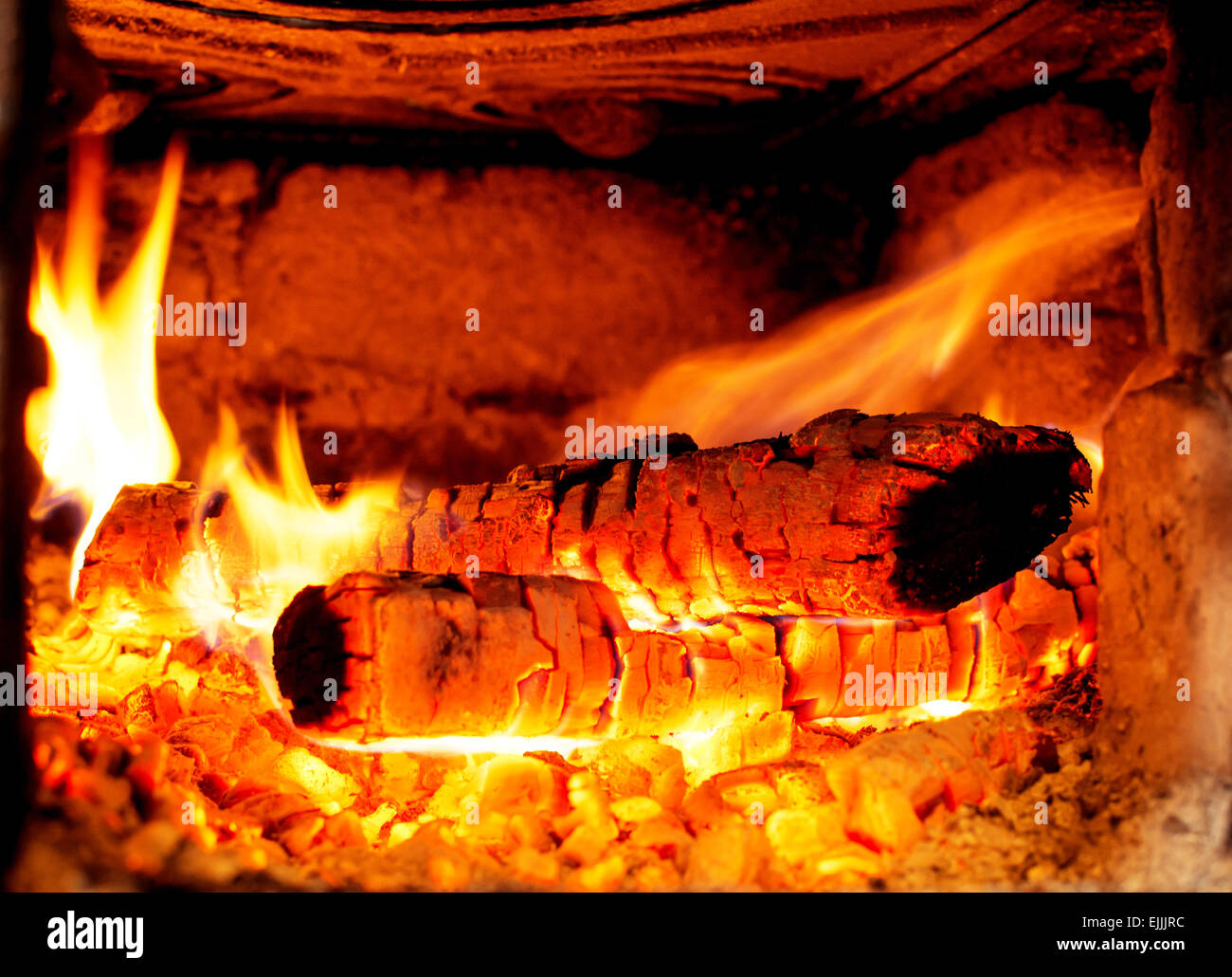 Logs on fire in the stove Stock Photo Alamy