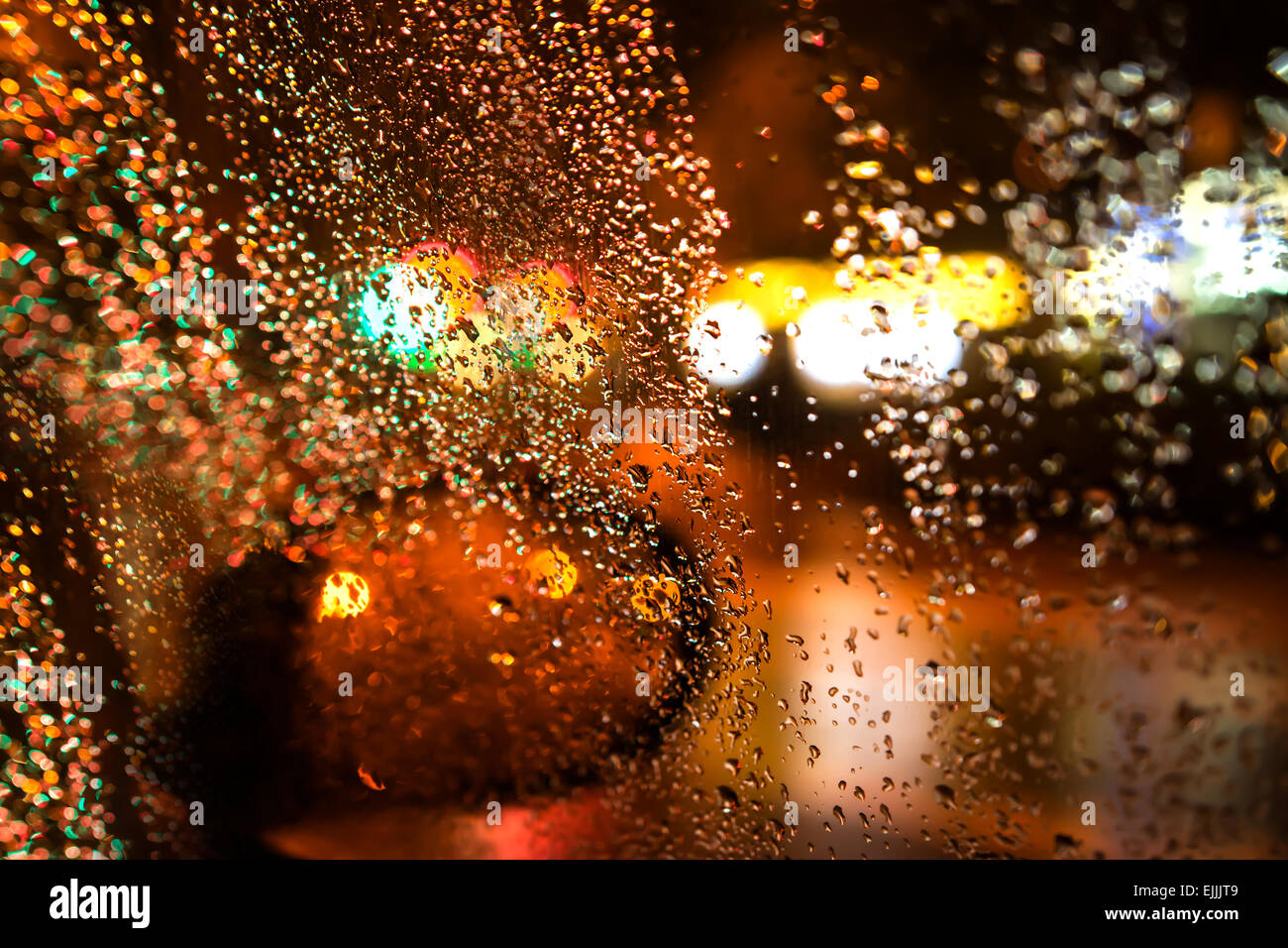 Rainy night through the car window. Stock Photo
