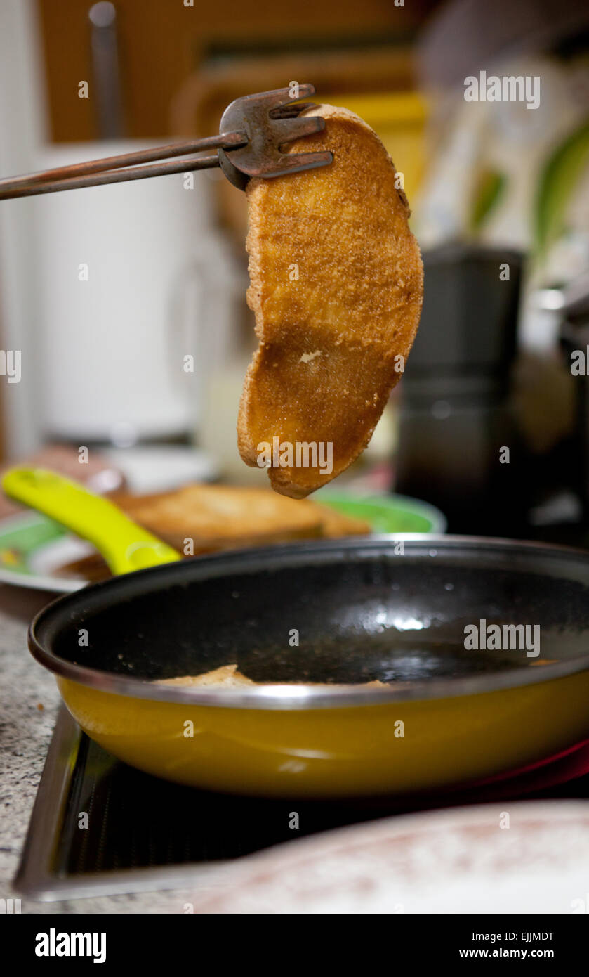 Preparation of fried bread slices, and spanish typical meal for breakfast, also called pringas