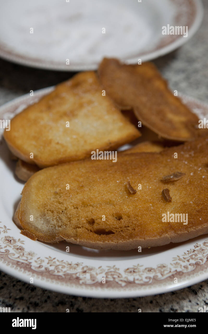 Preparation of fried bread slices, and spanish typical meal for breakfast, also called pringas