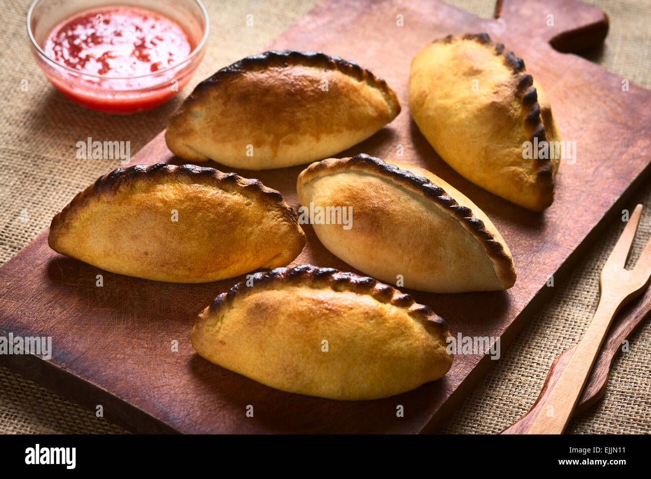 Traditional Bolivian savory pastries called Saltena filled with thick meat stew, which is a popular street snack in Bolivia Stock Photo