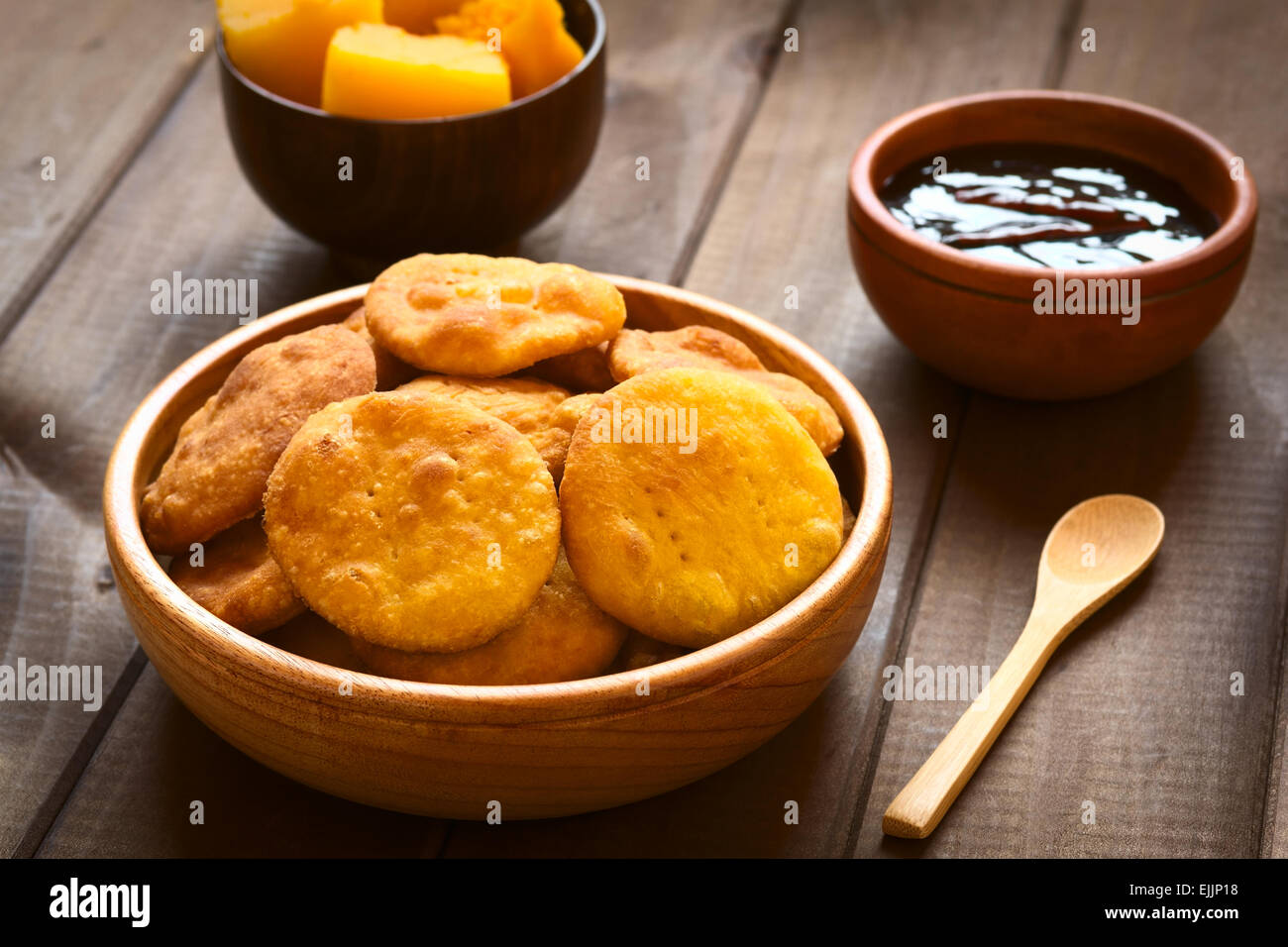 Traditional Chilean Sopaipilla fried pastry made with mashed pumpkin in the dough, served with Chancaca sweet sauce Stock Photo