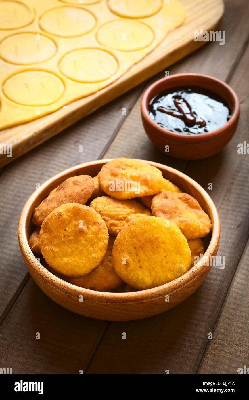 Traditional Chilean Sopaipilla fried pastry made with mashed pumpkin in the dough, served with Chancaca sweet sauce Stock Photo