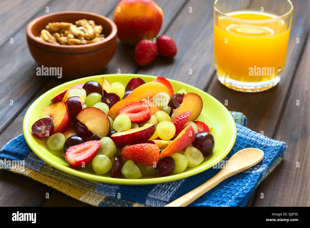 Fresh fruit salad made of grape, strawberry, plum and nectarine served