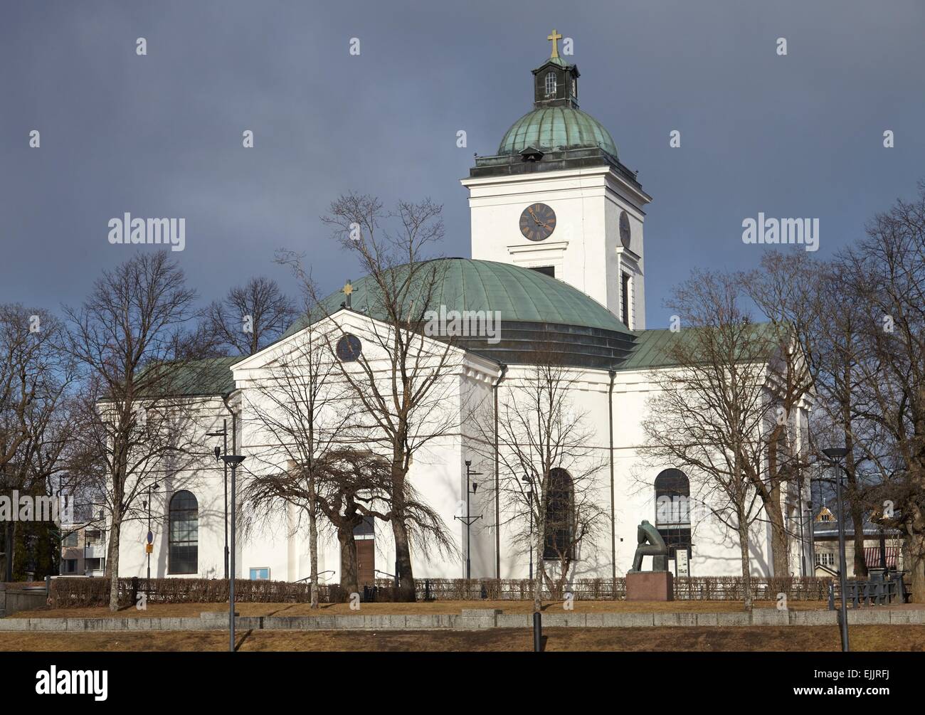 Small church of Hameenlinna in Finland. Early spring sun shining straight to the white walls of the building. Stock Photo