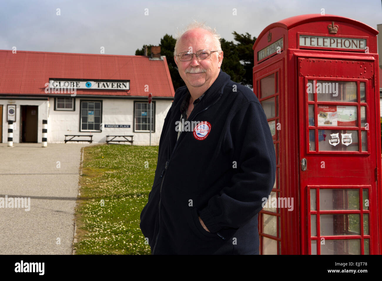 South Atlantic, Falklands, Port Stanley, male cruise ship passenger at Globe Tavern phone box Stock Photo