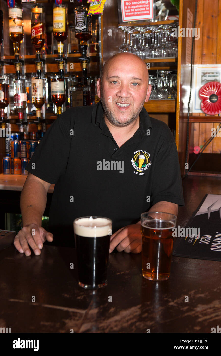 South Atlantic, Falklands, Port Stanley, Globe Tavern, pub barman Simon Fagan behind bar Stock Photo