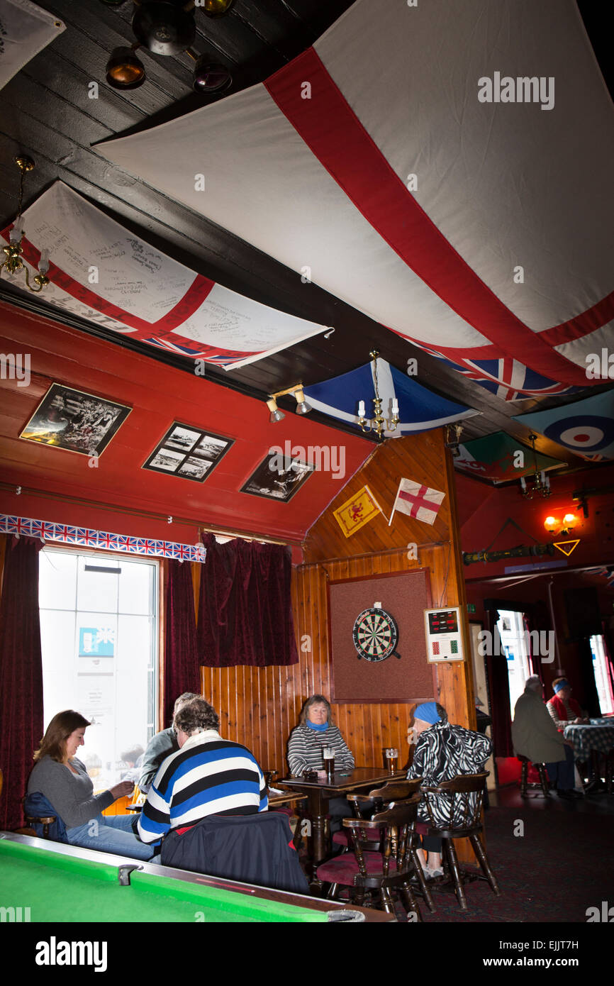 South Atlantic, Falklands, Port Stanley, Globe Tavern, customers sat in pub below flags Stock Photo