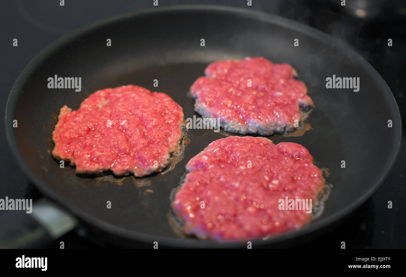 Ground beef patties in the pan Stock Photo Alamy