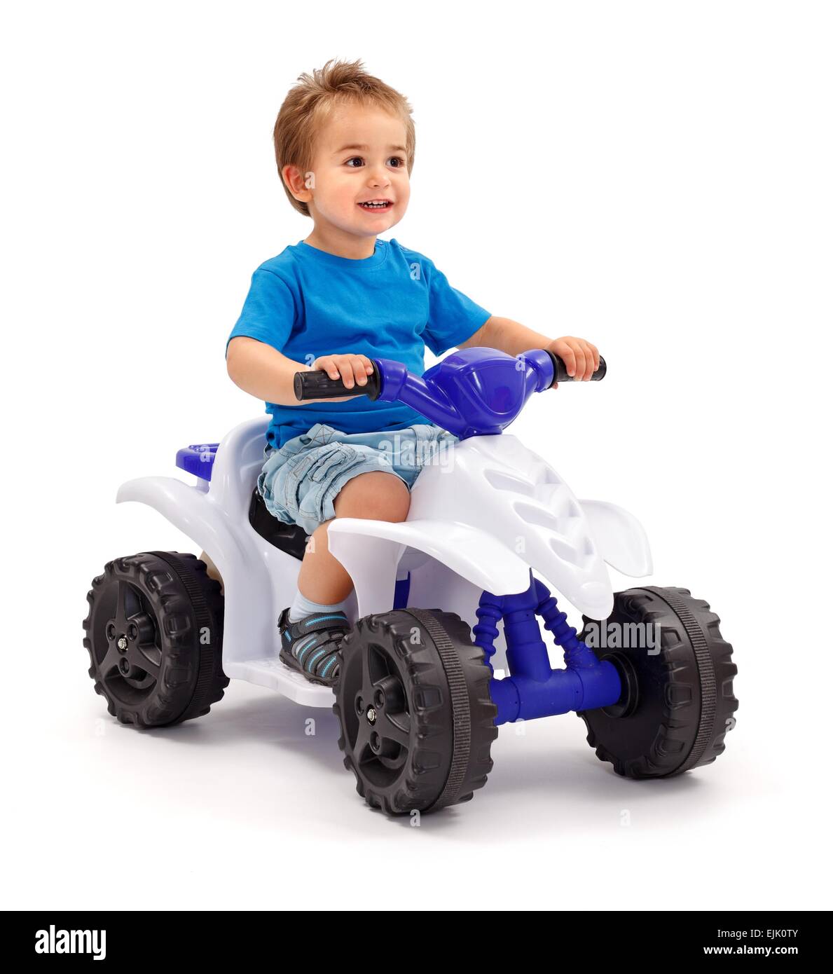 Little boy sitting on plastic toy car Stock Photo