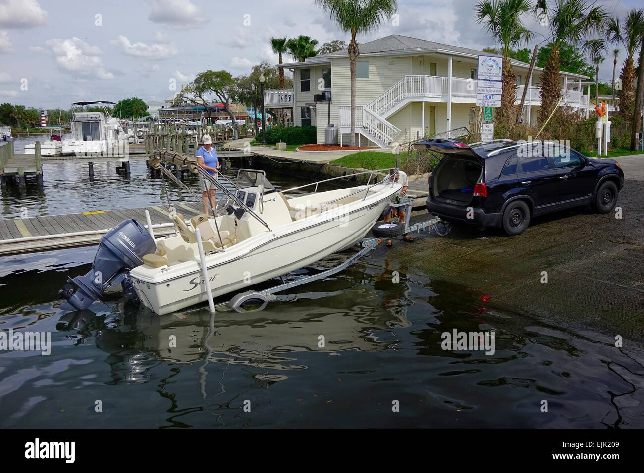 Couple launching boat from trailer at Homosassa River public boat ramp