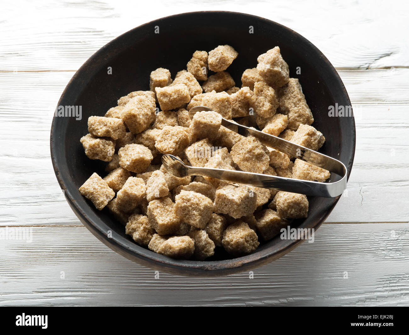 Cubes of cane sugar on wooden table. Stock Photo