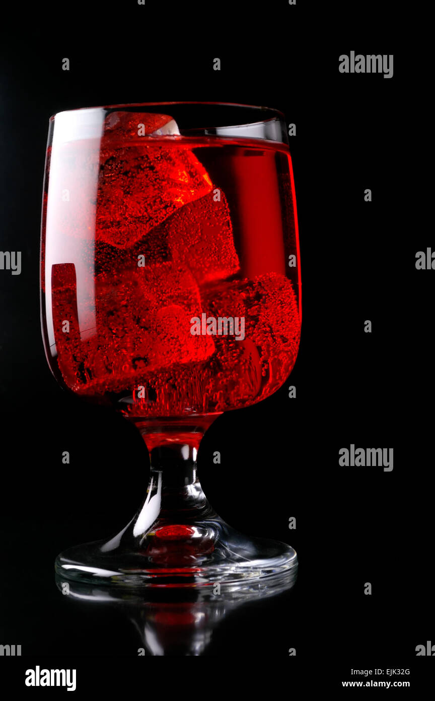 Glass of red drink with ice close-up Stock Photo